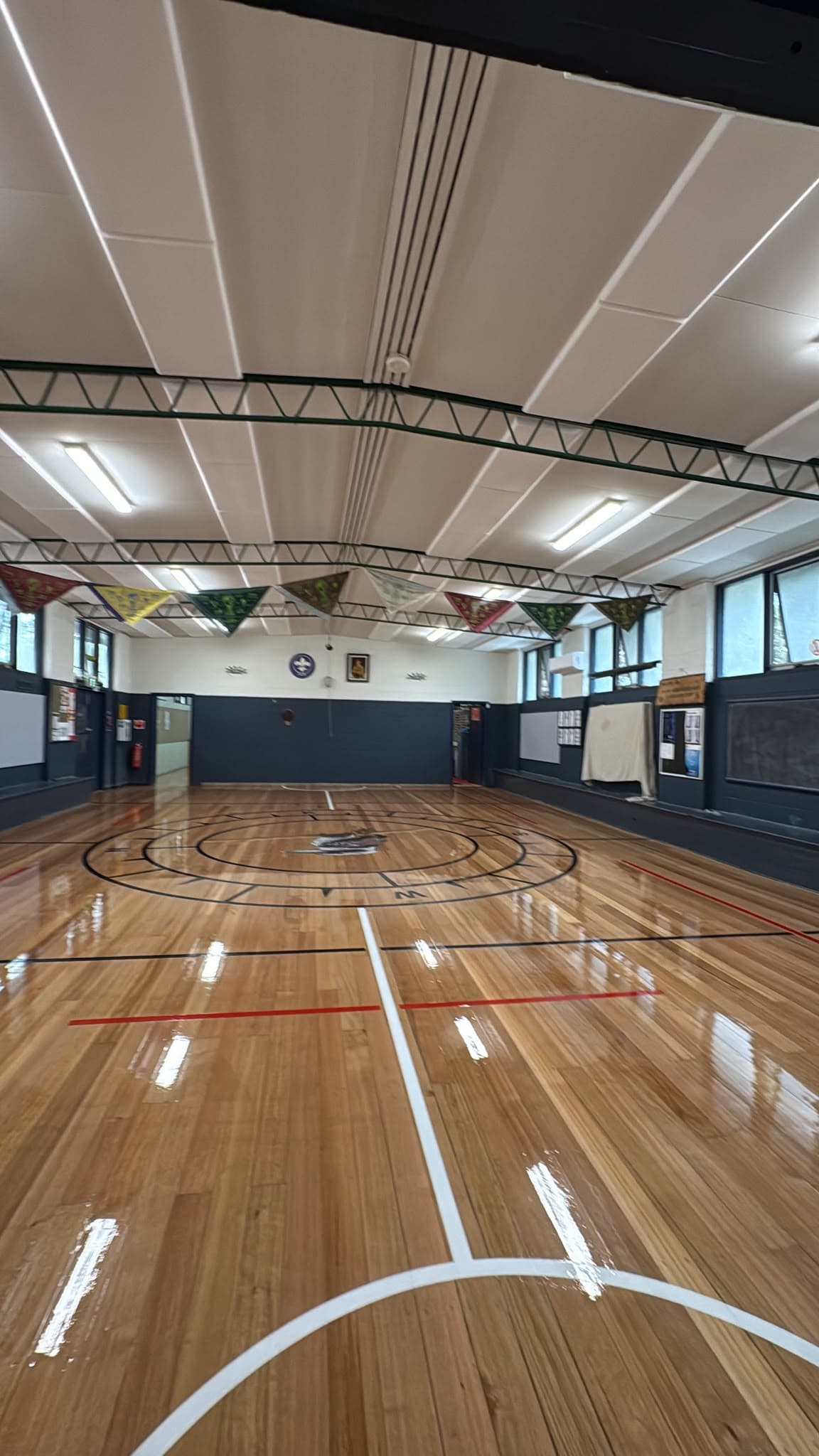 Resurfaced indoor basketball court with fresh line marking and a high-gloss seal